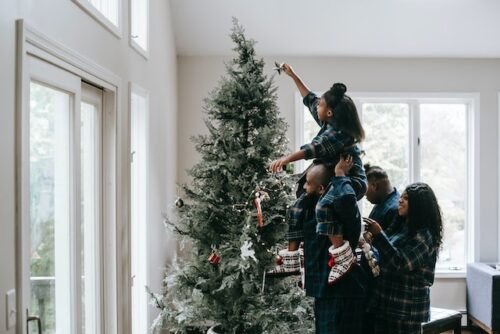 Family decorating holiday tree