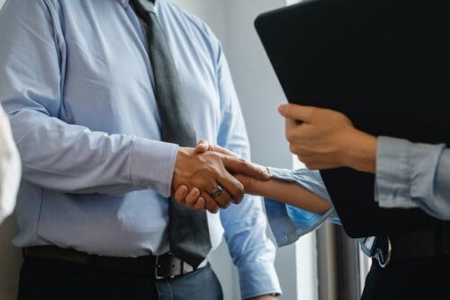 two people making a handshake agreement